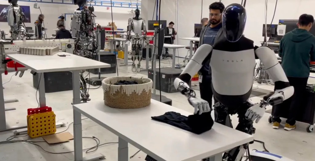 Tesla Optimus robot can’t build cars yet, but it is folding&nbsp;clothes